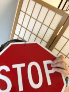 image of a woman pretending to be a stopsign
